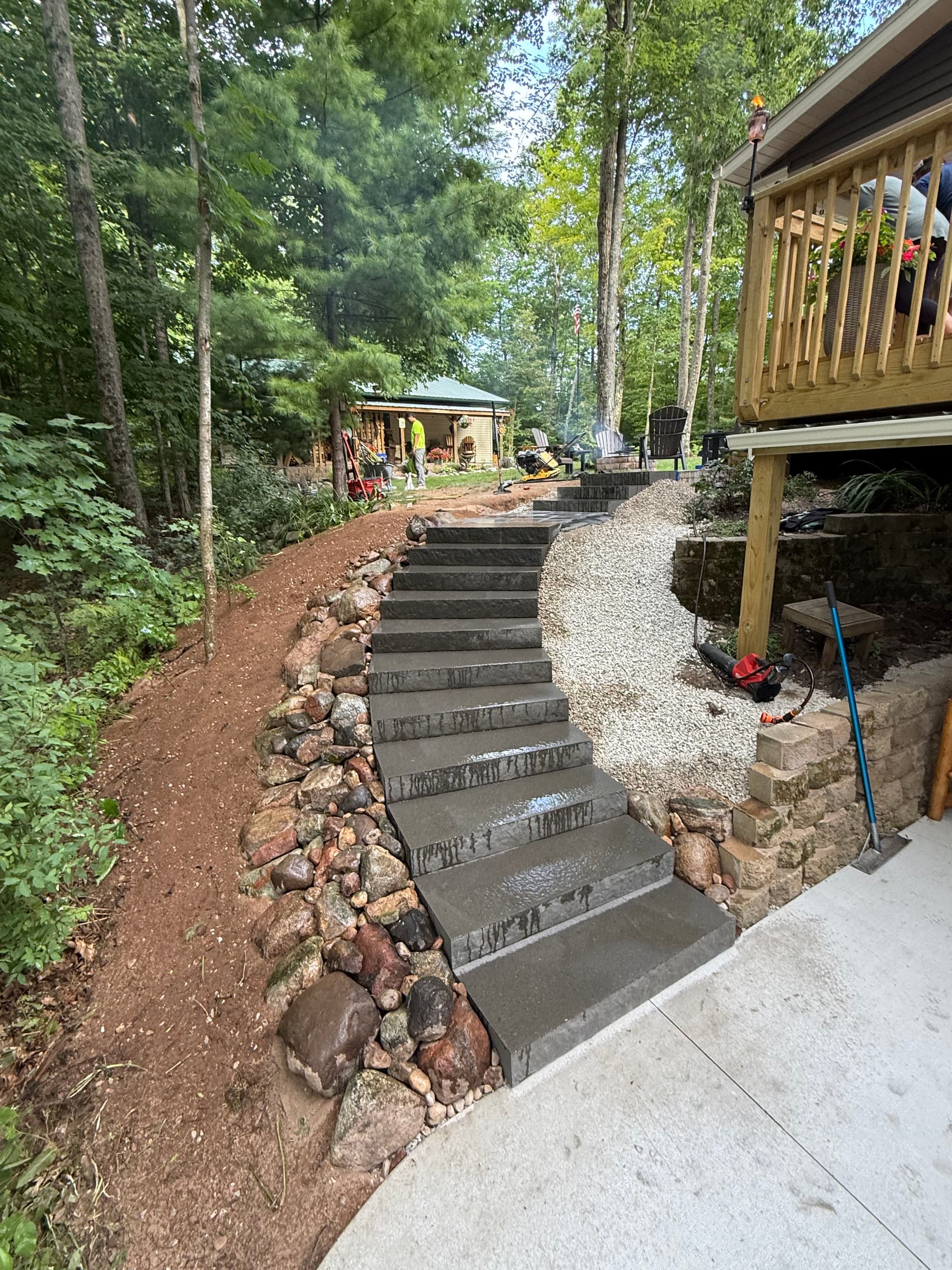 Concrete Steps and Paver Landing Built Into a Wooded Lakeside Property image