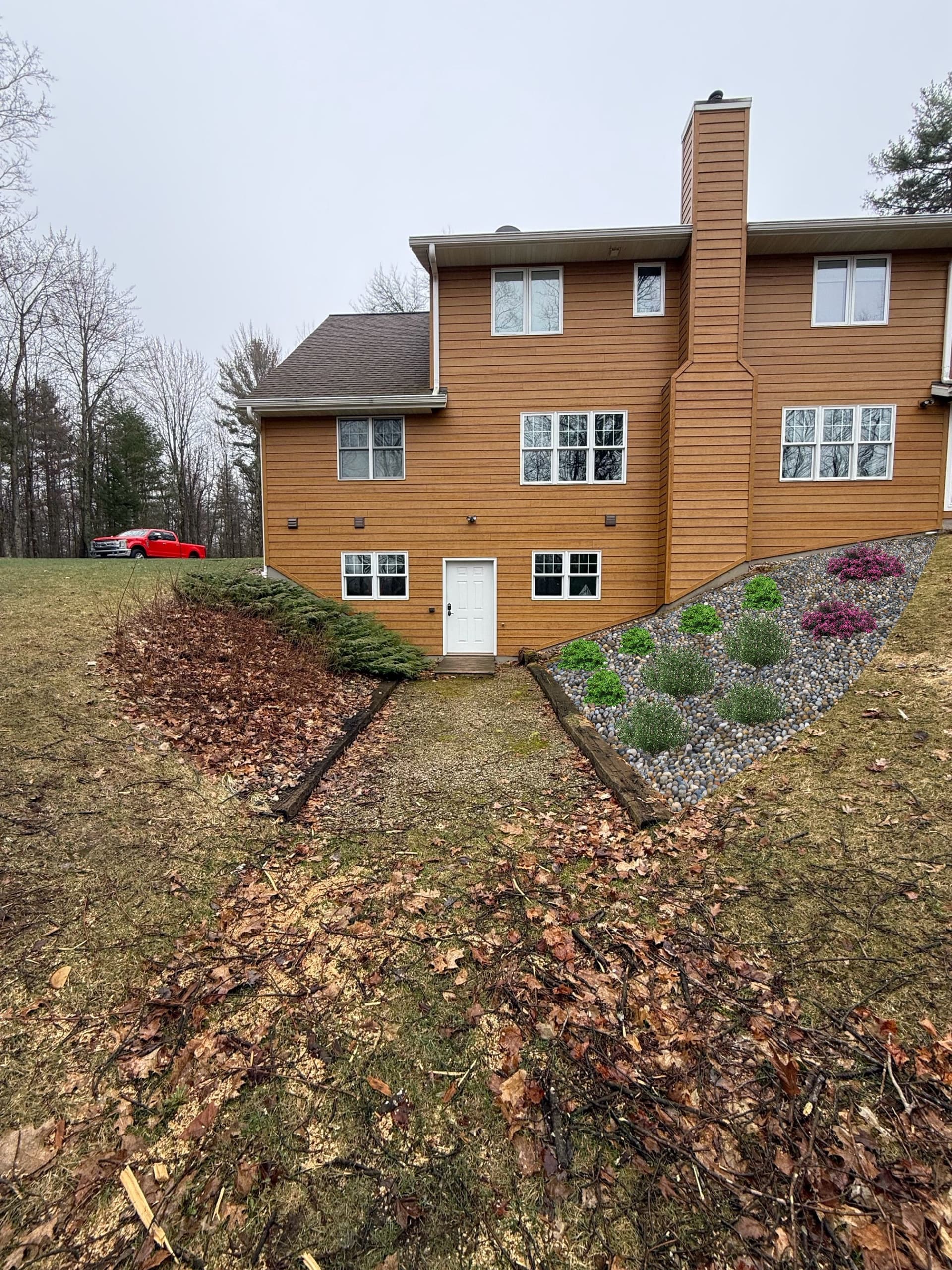 From Leaf-Covered Mess to Clean Stone Landscape Bed in One Day image
